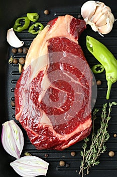 Piece of fresh beef meat, thyme and spices on grill pan, flat lay