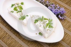 A piece of fresh cheese with herbs