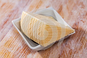 Piece of fresh semi-soft cheese