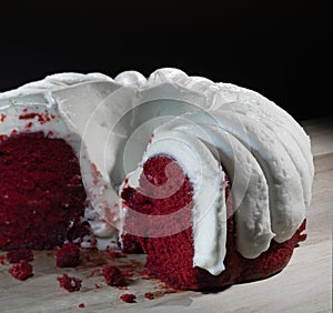 Piece gone from a red velvet cake