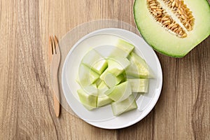 Piece of green melon fruit on plate ready to eating