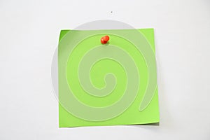 Piece of green paper template background with red pin