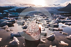 Piece of holding in hand in the Glacier lagoon, Iceland Jokulsarlon, iceberg