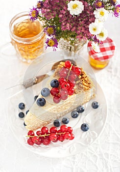 Piece of homemade honey cake with fresh berries