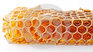 Piece of honeycomb, oozing with golden honey, isolated on white