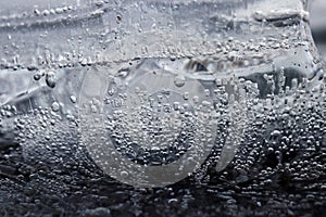 A piece of ice with frozen bubbles in the water