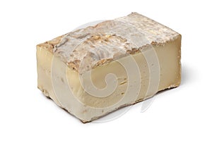 Piece of Italian Taleggio on white background close up