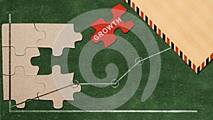 Piece of a jigsaw puzzle with growth text with increased graph on the chalkboard