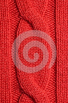 A piece of knitting orange sweater