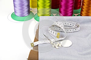 A piece of leatherette with needles and thread. Sewing workshop.