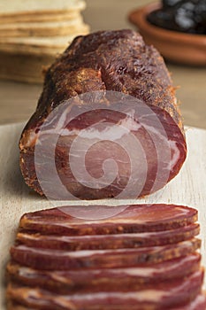 Piece of Lomo Embuchado meat and slices