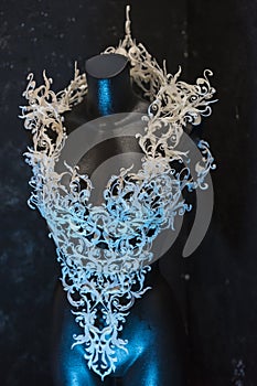 Piece made with 3d printer, is composed of white flowers that form a corset, handmade, fantasy design Baroque style