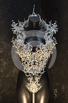 Piece made with 3d printer, is composed of white flowers that form a corset, handmade, fantasy design Baroque style