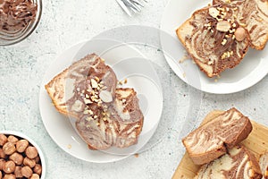 A piece of marble biscuit with chocolate cream and nuts