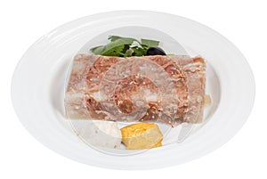 Piece of meat aspic with seasonings on white plate