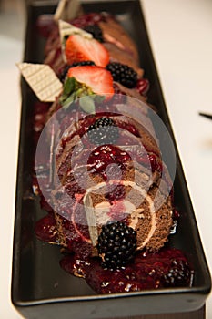 Piece of mini chocolate log cake with strawberry