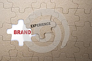 Piece of missing jigsaw puzzle with Brand Experience text