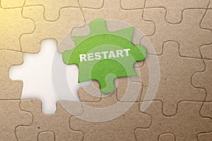 Piece of missing jigsaw puzzle with Restart text