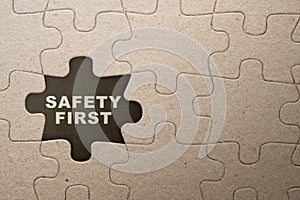 Piece of missing jigsaw puzzle with 'safety first' text
