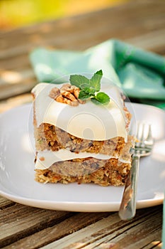 A Piece of Moist Zucchini and Walnut Cake with Cream Cheese Frosting