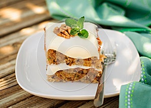 A Piece of Moist Zucchini and Walnut Cake with Cream Cheese Frosting