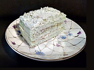 A piece of Mojito cake on a white saucer