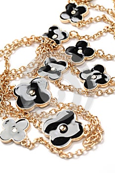 Piece of necklace chain with black flowers