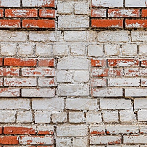 A piece of an old wall made of white and red bricks.