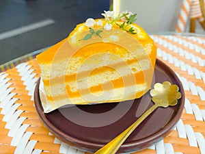 Piece of orange cake with fruit slice on top