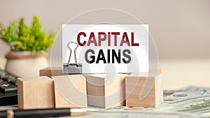 piece of paper with the text: CAPITAL GAINS. Business and finance concept