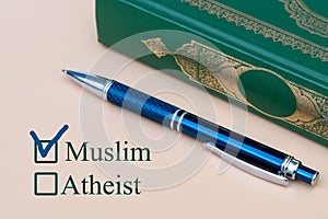 On a piece of paper are written Muslim and Atheist with a choice. religion Muslim or unbeliever checkbox on white paper with pen.