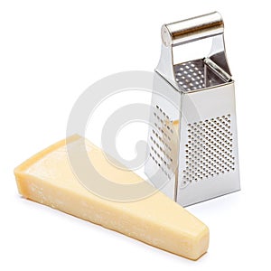 Piece of parmesan cheese and grater isolated on white background