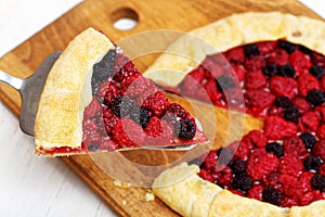 Piece of pie with red and black raspberries