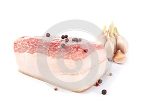 Piece of pork fatback with peppercorn and garlic isolated