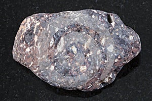 piece of porous basalt stone on dark background