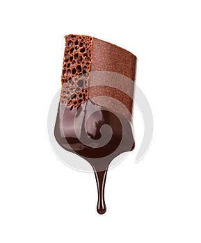 Piece of porous chocolate with a drop