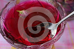 A piece of raspberry jelly scooped into a dessert spoon