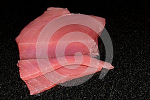 Piece of raw fresh red tuna for healthy eating. Preparation of Yellow fin sashimi.