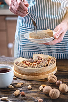 Piece of raw nutty cake on a blue wooden background. Healthy fresh summer vegan dessert. Gluten free and sugar free food