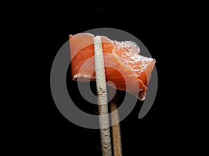 A piece of red fish on a dark background