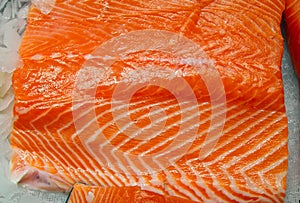 A piece of red fish in ice close-up. Sectional salmon