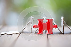 Piece of Red   jigsaw puzzle On the old wood. teamwork concept.  symbol of association and connection. business strategy