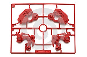 A piece of red plastic scale model kit set with futuristic robotic parts