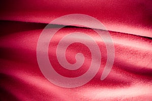 Piece of red wrinkled cotton cloth close up background texture