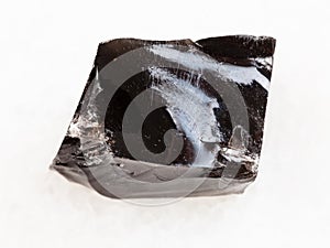 piece of rough Obsidian stone on white