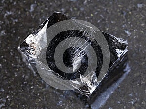 piece of rough Obsidian (volcanic glass) on dark