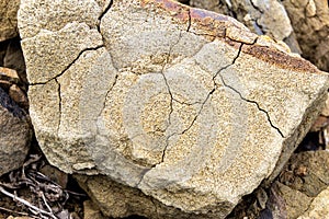 a piece of sandstone cracked under the influence of atmospheric phenomena