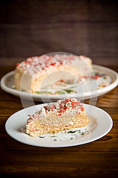 Piece of snack cake stuffed with crab sticks in a plate