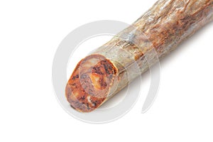 Piece of Spanish chorizo sausage Chorizo iberico on white background.