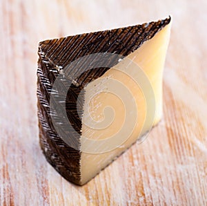 Piece of spanish hard cheese Anejo from sheep milk photo